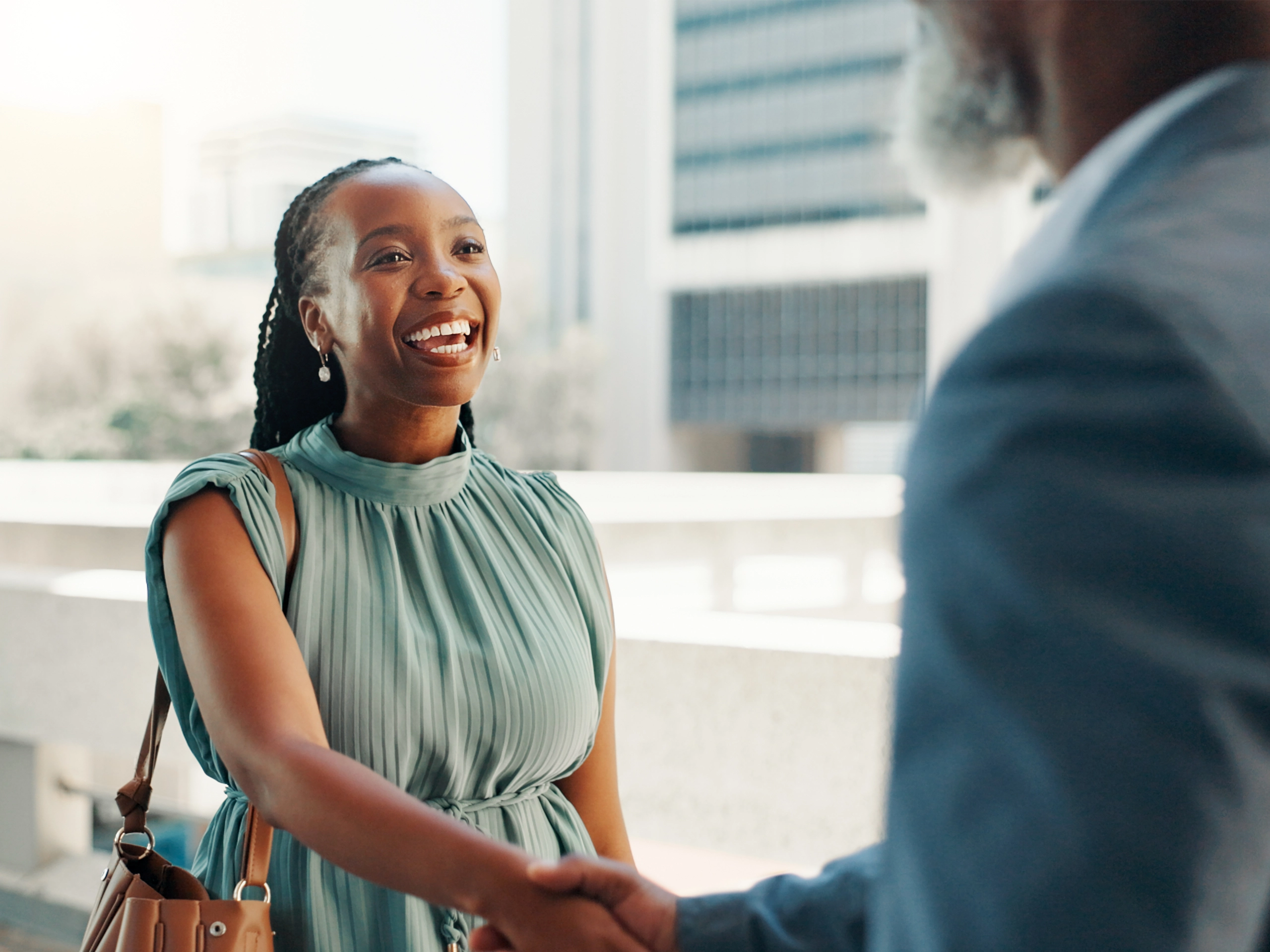 Business woman in city as a real estate developer, shaking hands with partner