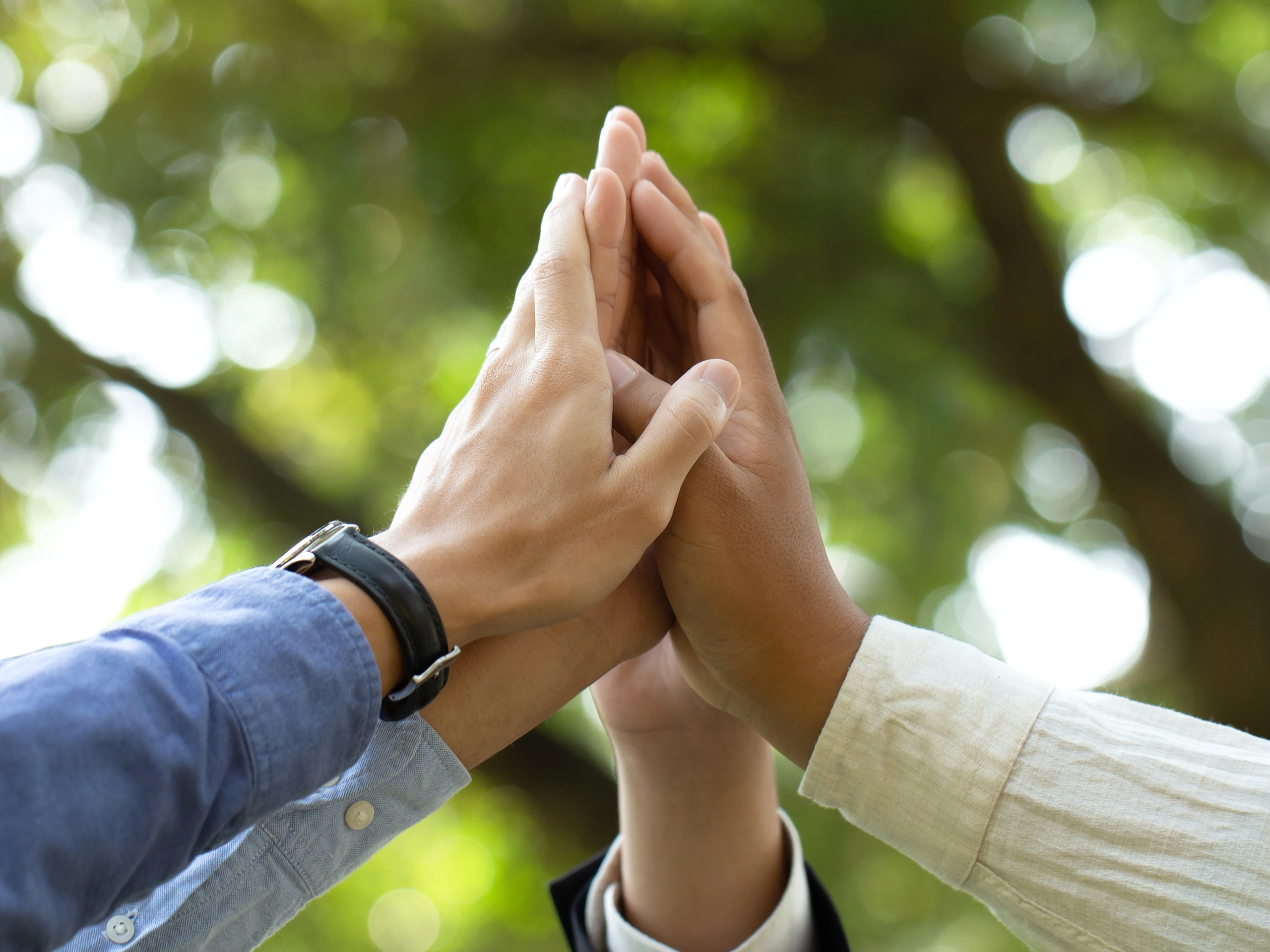 World environment day. Global community teamwork, CSR, and ESG environmental energy-saving collaboration of hands stack together for sustainable development goals. People join for cooperation success.