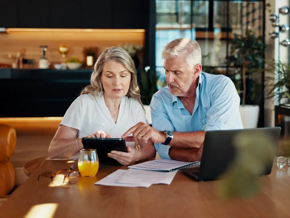 Couple reading business documents on a tablet