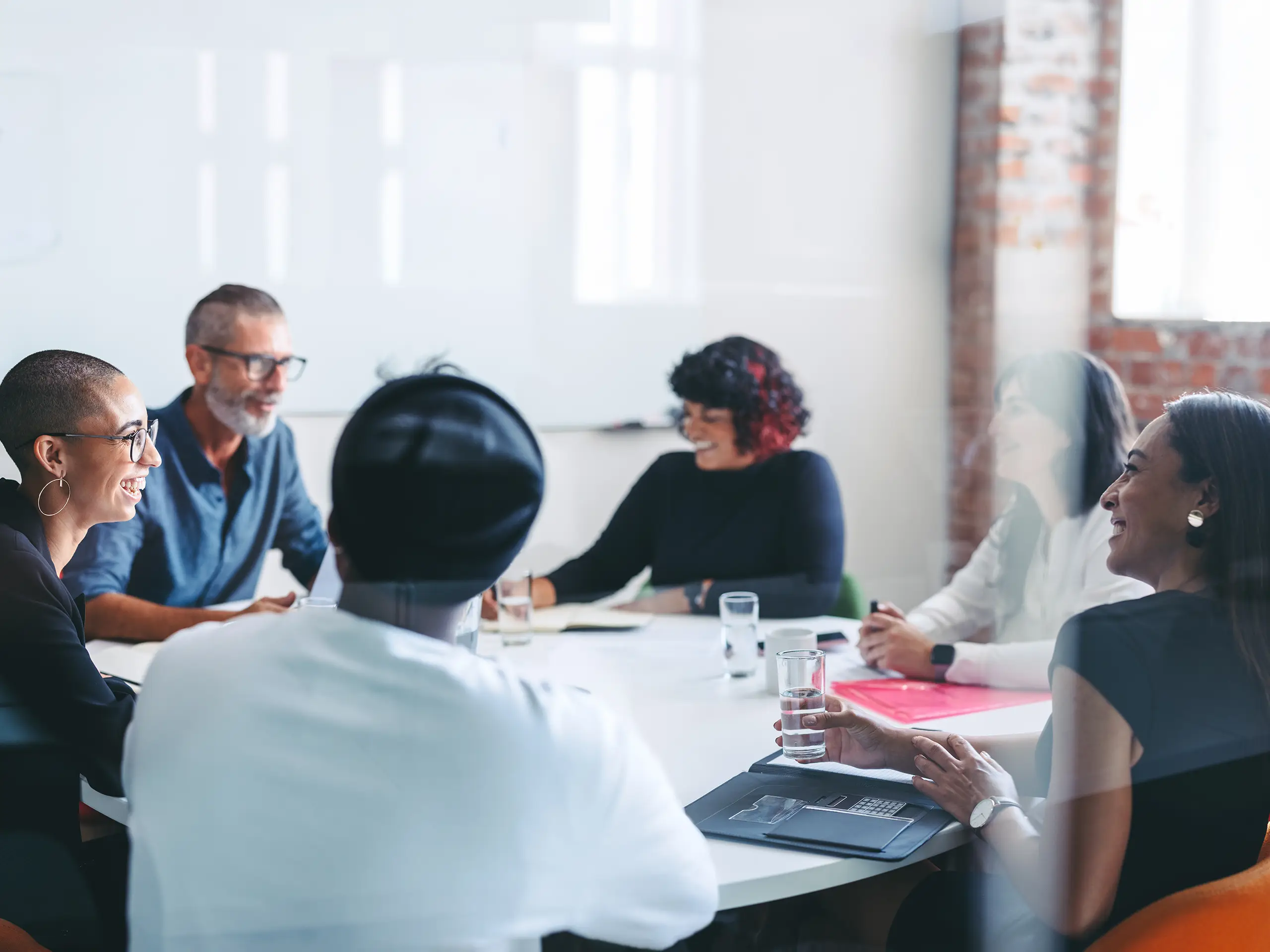 A group of professionals sitting around a table in a meeting